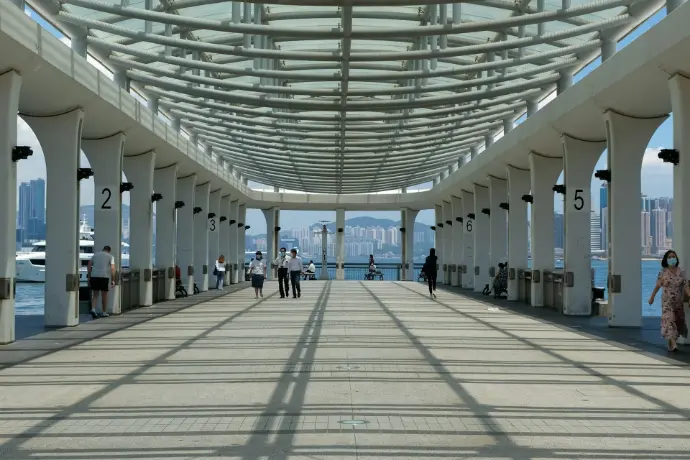 people walking on white and gray hallway